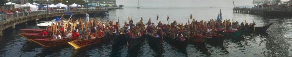 Salmon Homecoming boats lined up at the shore in downtown Seattle